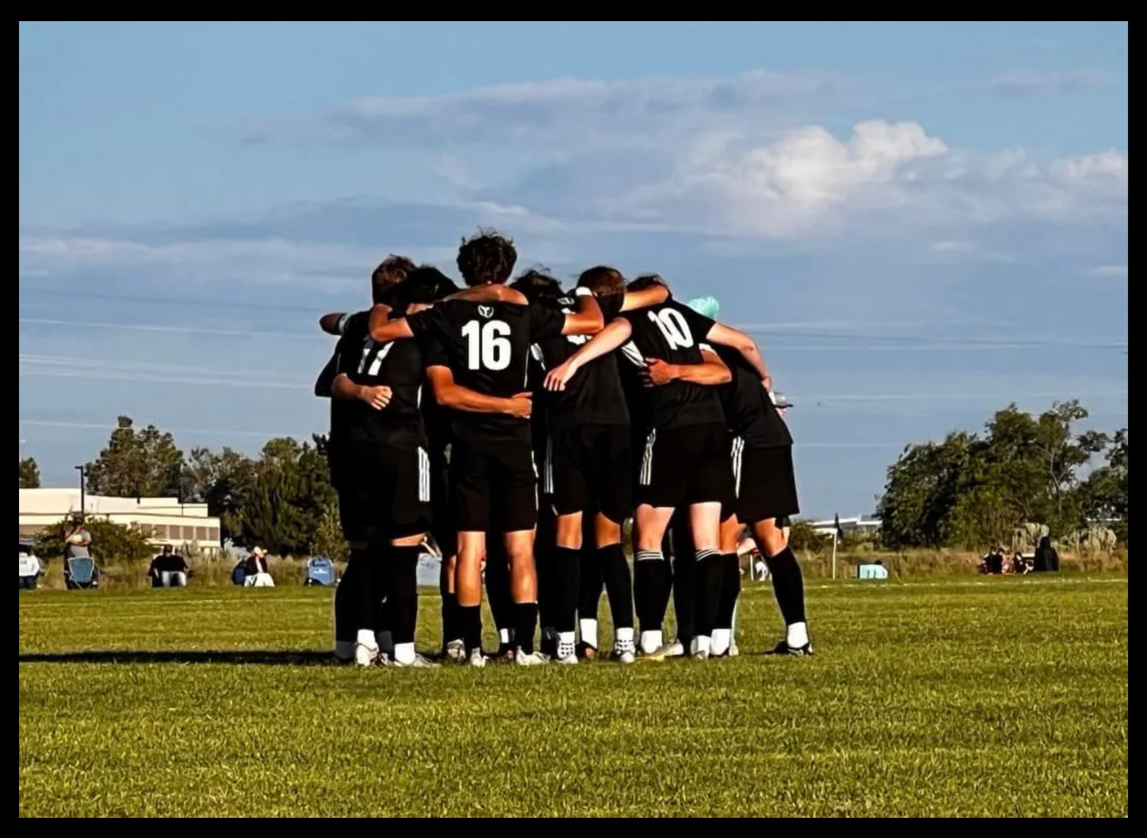 Bend FC team huddle on the field